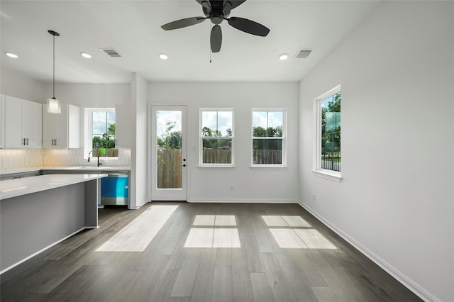 kitchen featuring visible vents, backsplash, dark wood-style floors, and light countertops