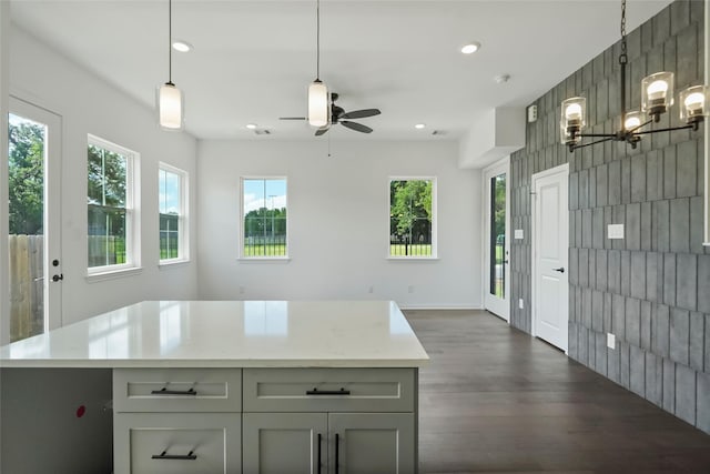 kitchen featuring open floor plan, pendant lighting, light countertops, recessed lighting, and ceiling fan with notable chandelier