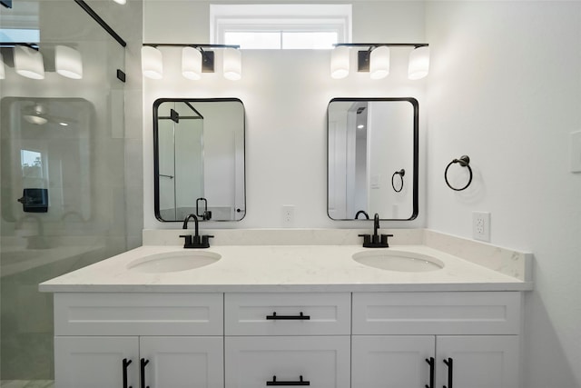 full bath featuring a sink, a shower stall, and double vanity