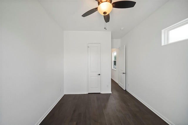 spare room featuring a ceiling fan, wood finished floors, and baseboards