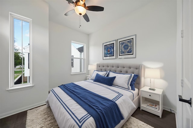 bedroom featuring baseboards, dark wood-type flooring, and a ceiling fan