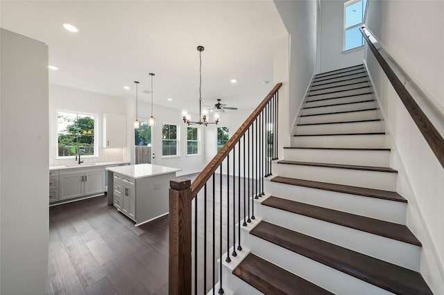 staircase featuring a chandelier, recessed lighting, and wood finished floors