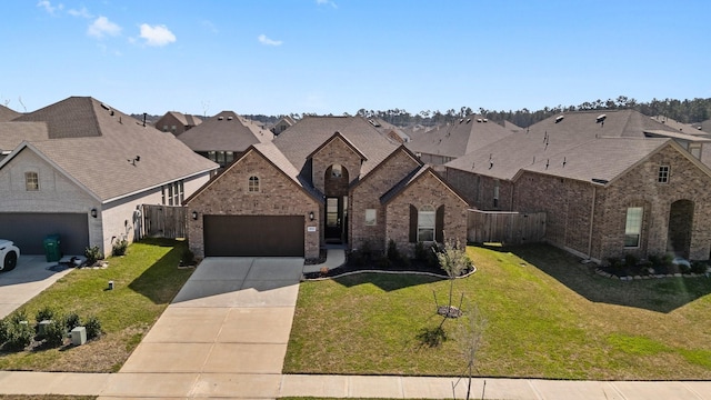 french country home featuring fence, concrete driveway, a front yard, a garage, and brick siding