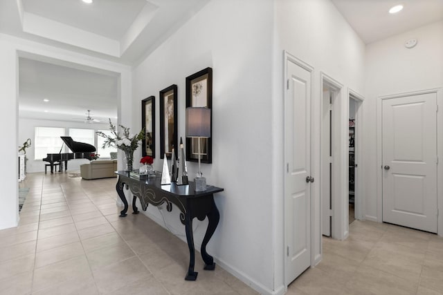 corridor with light tile patterned floors, recessed lighting, and baseboards