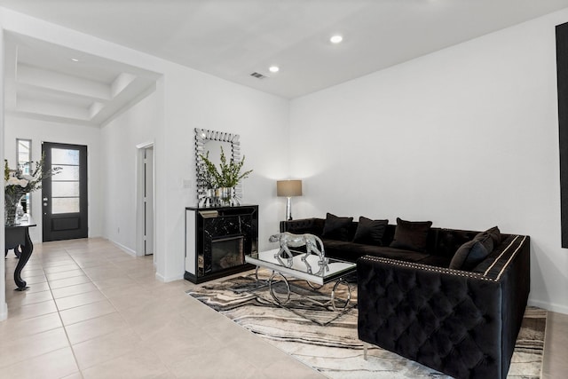 tiled living room featuring recessed lighting, visible vents, baseboards, and a fireplace