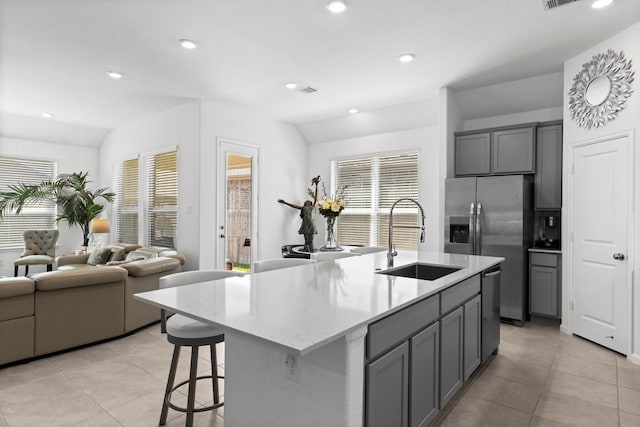 kitchen with a sink, dishwasher, open floor plan, and gray cabinets