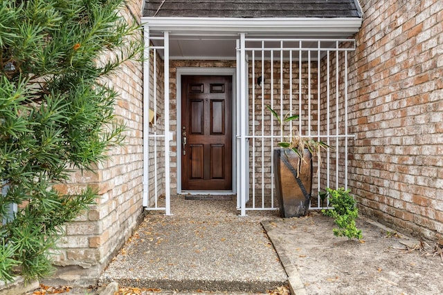 doorway to property featuring brick siding