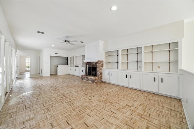 unfurnished living room with baseboards, visible vents, recessed lighting, a fireplace, and ceiling fan