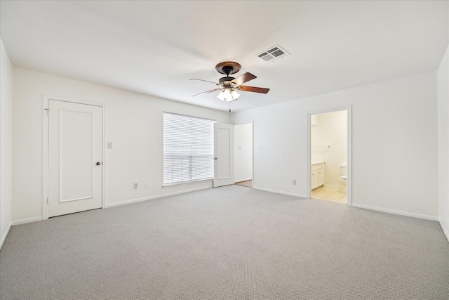 unfurnished room featuring visible vents, light carpet, baseboards, and a ceiling fan