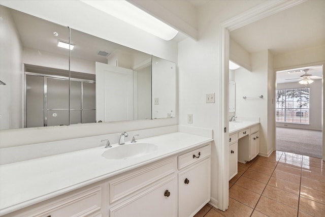 full bath featuring vanity, baseboards, ceiling fan, an enclosed shower, and tile patterned floors