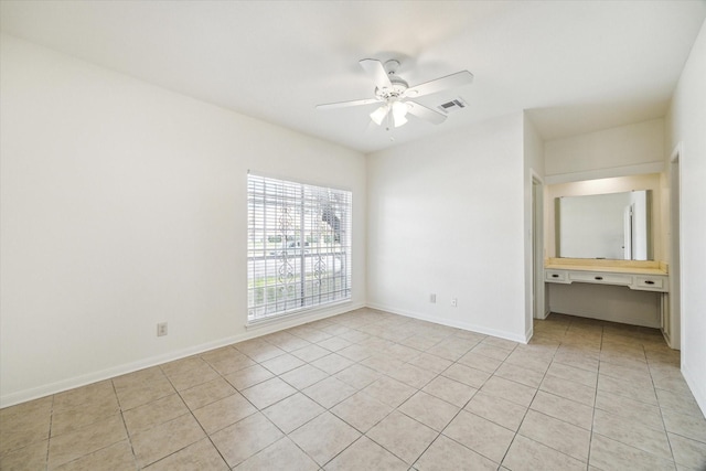 unfurnished bedroom featuring a ceiling fan, light tile patterned flooring, baseboards, and visible vents