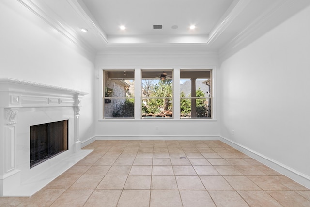 unfurnished living room with light tile patterned floors, baseboards, visible vents, a high end fireplace, and ceiling fan