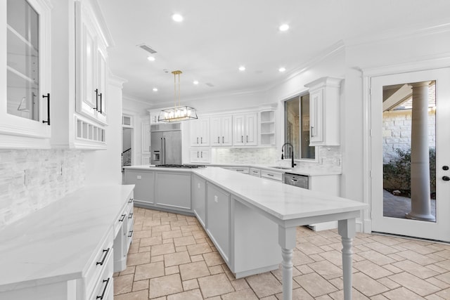 kitchen with a kitchen island, ornamental molding, stainless steel appliances, white cabinetry, and open shelves