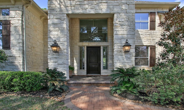 view of exterior entry featuring stone siding