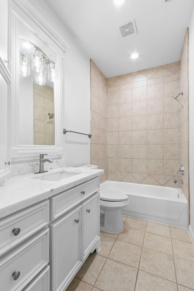 bathroom featuring vanity, visible vents, shower / washtub combination, tile patterned floors, and toilet