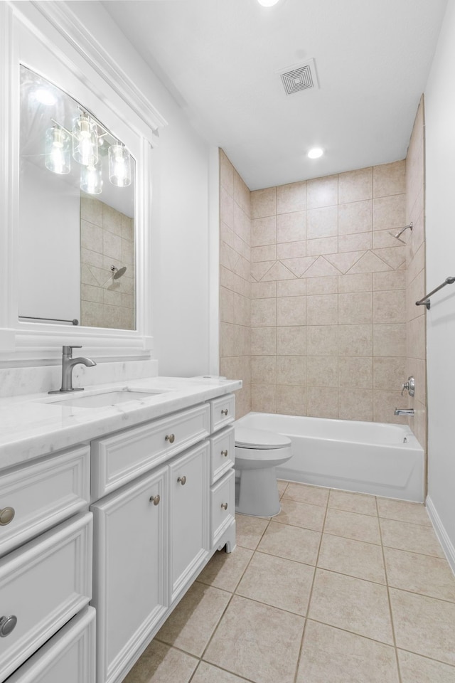 bathroom featuring tile patterned floors, visible vents, toilet, tub / shower combination, and vanity