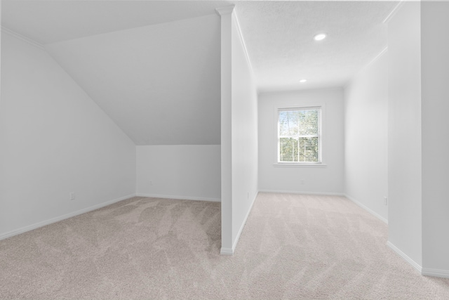 additional living space featuring recessed lighting, baseboards, lofted ceiling, and carpet