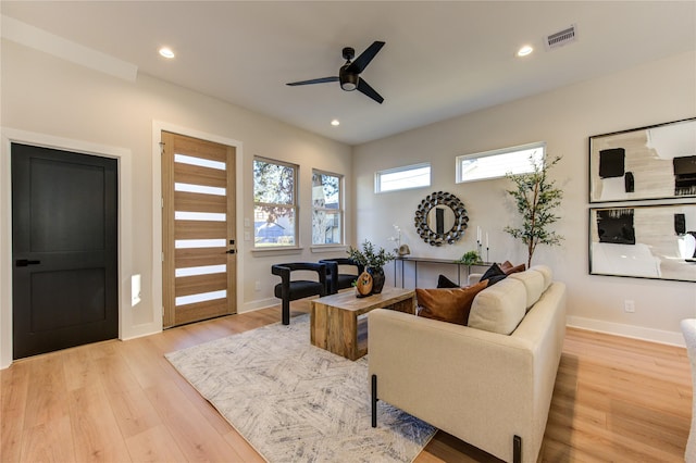 living area featuring recessed lighting, light wood-type flooring, visible vents, and a ceiling fan