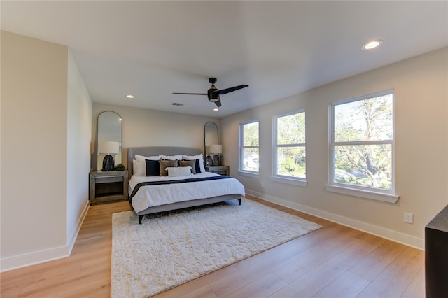 bedroom with a ceiling fan, visible vents, baseboards, recessed lighting, and light wood-style floors