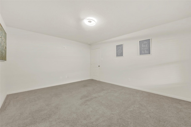 empty room with carpet flooring and baseboards