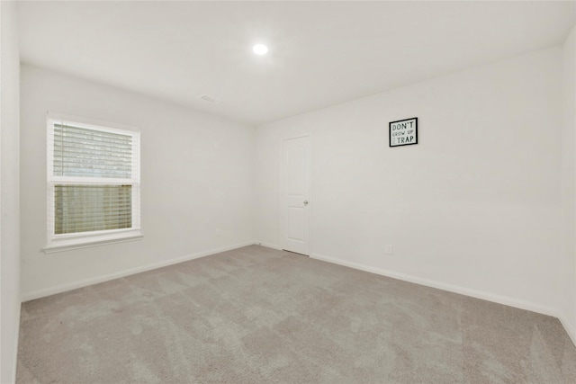 empty room with recessed lighting, baseboards, and light carpet