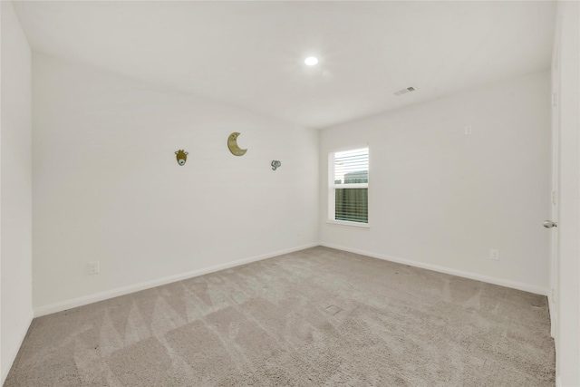 spare room with visible vents, baseboards, and carpet