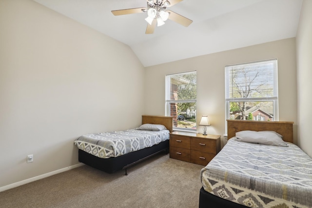 bedroom with a ceiling fan, vaulted ceiling, light colored carpet, and baseboards