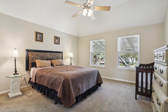 bedroom with carpet flooring, a ceiling fan, baseboards, and vaulted ceiling