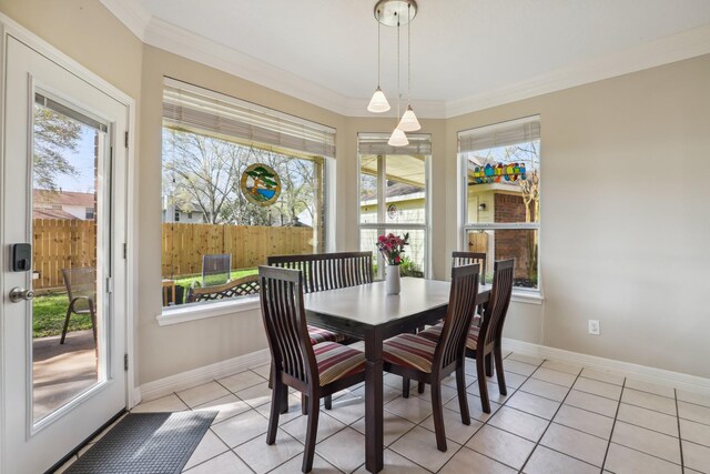 dining space featuring light tile patterned flooring, baseboards, and ornamental molding