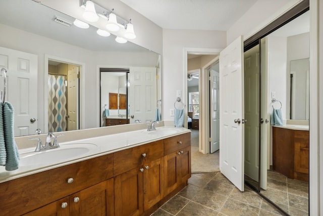 full bathroom with a sink, visible vents, and double vanity