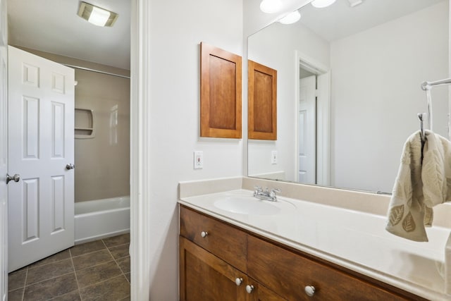 full bath featuring washtub / shower combination, vanity, and tile patterned flooring