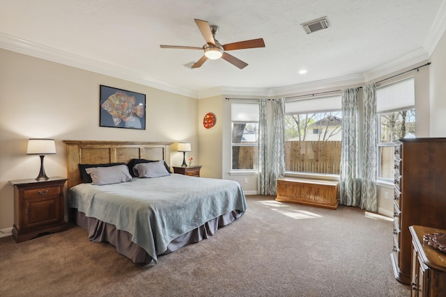 bedroom with crown molding, carpet flooring, baseboards, and visible vents