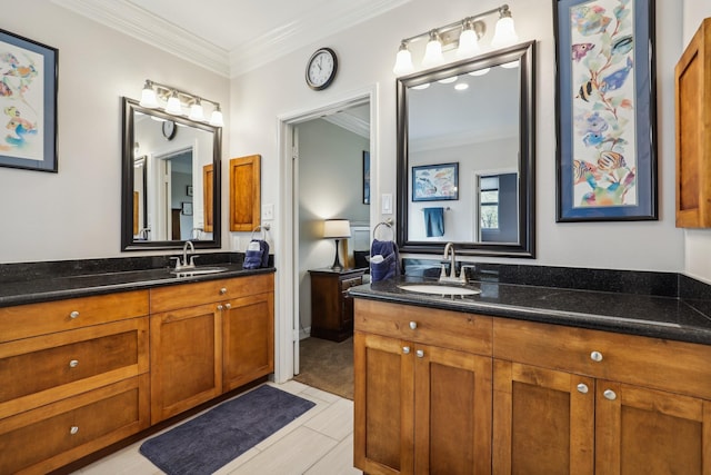 bathroom featuring crown molding, two vanities, and a sink