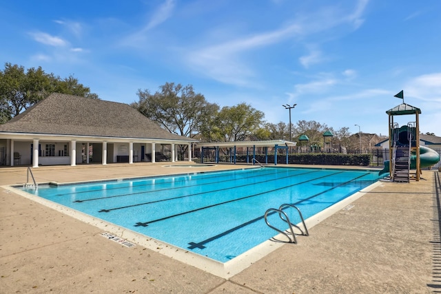 pool featuring a patio, fence, and playground community