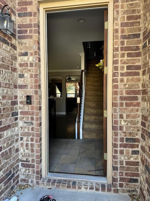 property entrance featuring brick siding