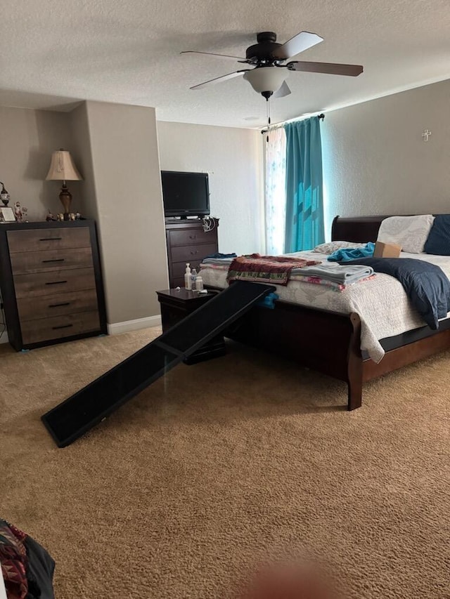 bedroom featuring ceiling fan, baseboards, and a textured ceiling