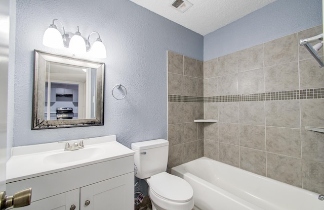 full bath featuring visible vents, toilet, a textured ceiling, vanity, and a textured wall