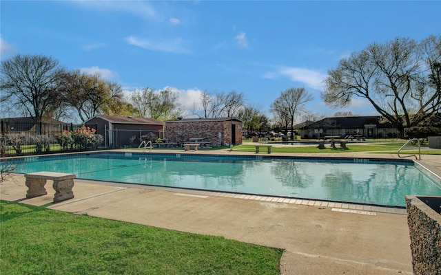 community pool featuring a yard and fence