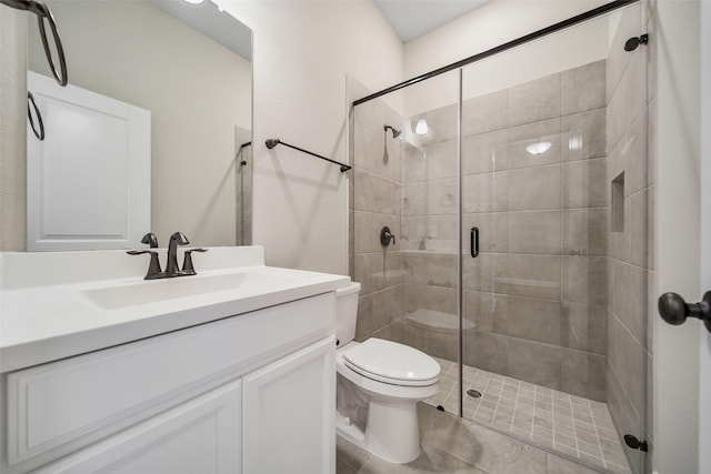 full bath featuring vanity, toilet, and a stall shower