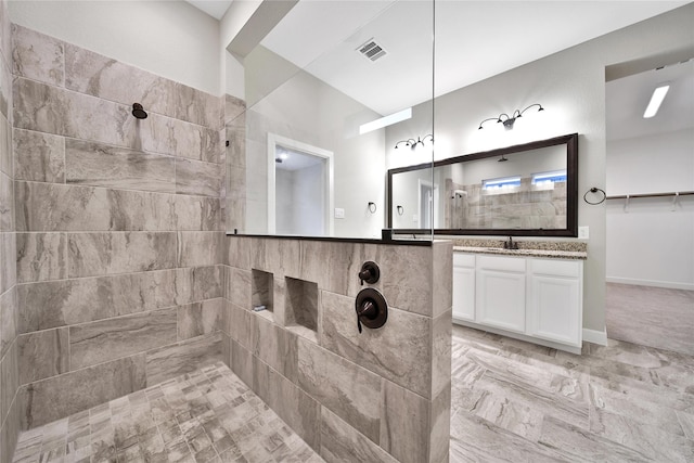 32193 Park Plains Dr, Conroe, TX 77385 - bathroom featuring a walk in shower, vanity, and marble look tiles