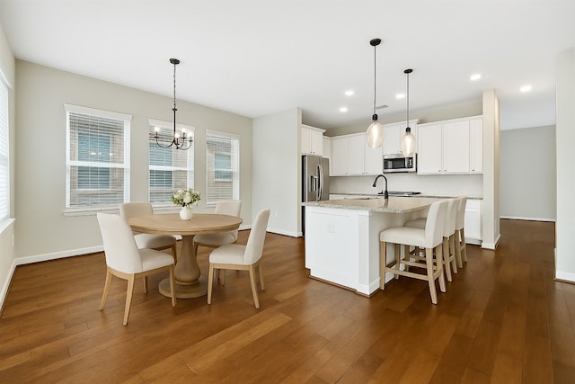 32193 Park Plains Dr, Conroe, TX 77385 - kitchen featuring appliances with stainless steel finishes, a kitchen island with sink, a chandelier, dark wood-style floors, and recessed lighting