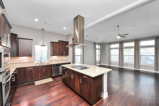 kitchen featuring a ceiling fan, visible vents, island exhaust hood, appliances with stainless steel finishes, and a center island