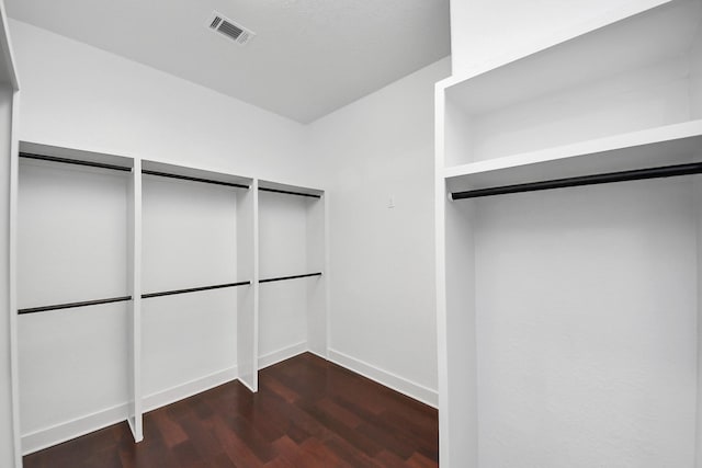 spacious closet with visible vents and dark wood-style floors