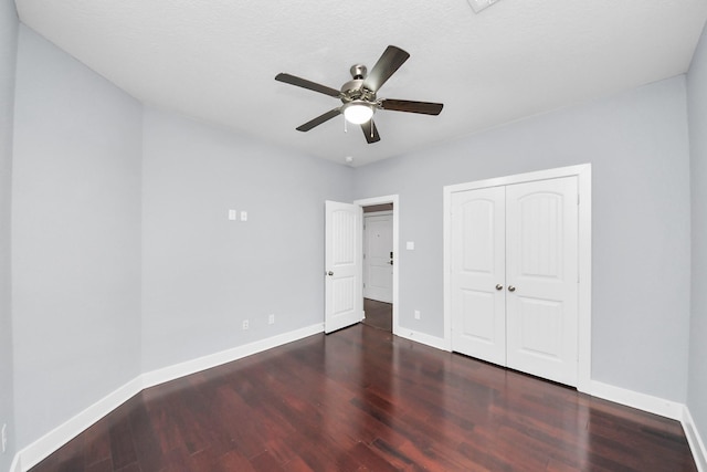 unfurnished bedroom with a closet, a ceiling fan, baseboards, and wood finished floors