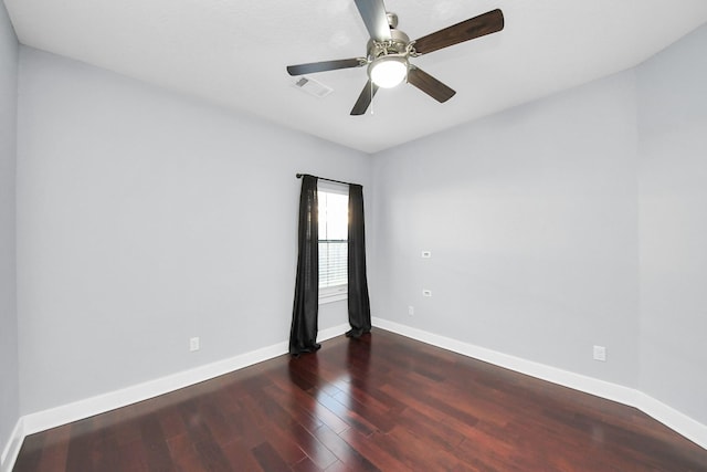 unfurnished room with visible vents, baseboards, wood finished floors, and a ceiling fan