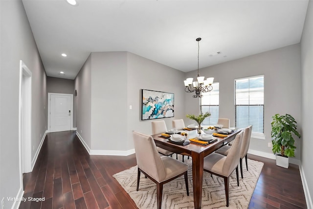 dining area featuring dark wood finished floors, a notable chandelier, recessed lighting, and baseboards