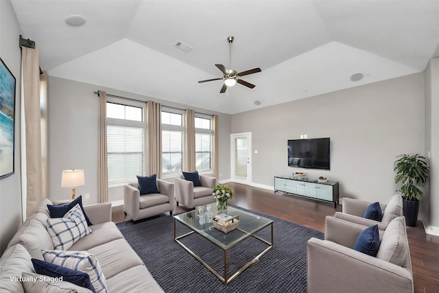 living room featuring visible vents, dark wood-style floors, baseboards, ceiling fan, and vaulted ceiling