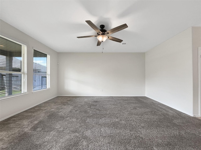 empty room featuring visible vents, baseboards, ceiling fan, and carpet flooring