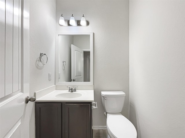 bathroom featuring toilet and vanity