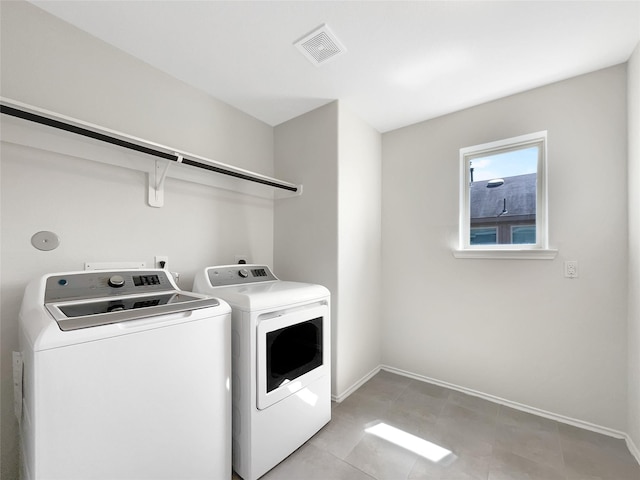 laundry room featuring washer and dryer, visible vents, baseboards, and laundry area